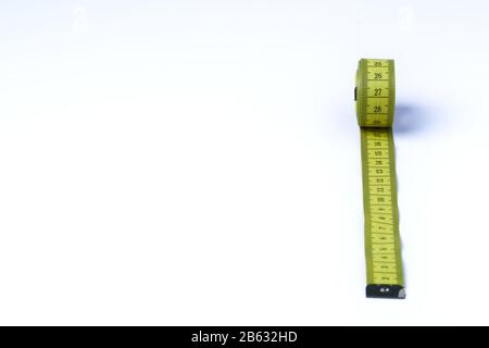 A yellow tape measure in centimeters on a white background Stock Photo