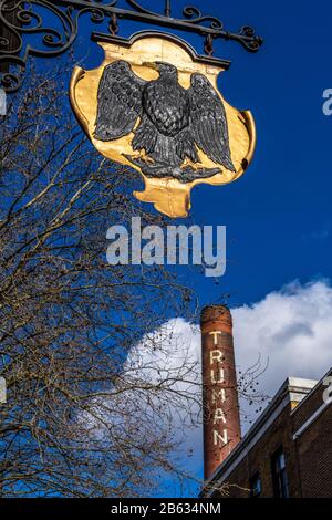 Brick Lane London - The Old Truman Brewery chimney and eagle symbol on London’s Brick Lane, Shoreditch, East London. Stock Photo