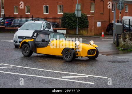 A yellow Caterham 7, a continuation of the original Lotus 7, on a damp dreary morning in Devizes Wiltshire Stock Photo