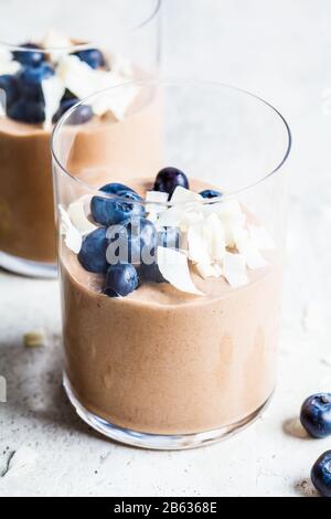 Chocolate mousse smoothie with berries and coconut in a glass for breakfast. Stock Photo