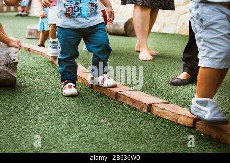 litttle kids walking and playing outdoors Stock Photo