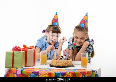 Children eat a birthday cake with a spoon, isolated on a white background Stock Photo