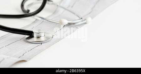 Stethoscope and cardiogram on white background. Copy space Stock Photo