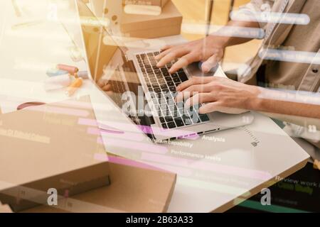 Seamstress works to new clothes ordered by internet client Stock Photo
