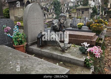 Grave of Russian ballet dancer Vaslav Nijinsky (1890-1950) at Montmartre Cemetery (Cimetière de Montmartre) in Paris, France. The bronze statue of Vaslav Nijinsky as Petrushka designed Russian sculptor Oleg Abaziev was added to the grave in 1997. Stock Photo