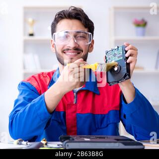Repairman working in technical support fixing computer laptop troubleshooting Stock Photo