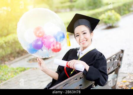 Portrait of happy young female graduates in academic dress and square academic cap holding word quotes of CONGRATS GRAD on balloon after convocation c Stock Photo - Alamy Portrait of happy young female graduates in academic dress and square academic cap holding word quotes of CONGRATS GRAD on balloon after convocation c Stock Photo - Alamy