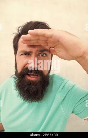 Suspicious look. Man bearded hipster stylish beard grey background. Perceptions of male beauty. Stylish beard and mustache care. Strict face. Beard fashion barber. Handsome guy. Masculinity concept. Stock Photo