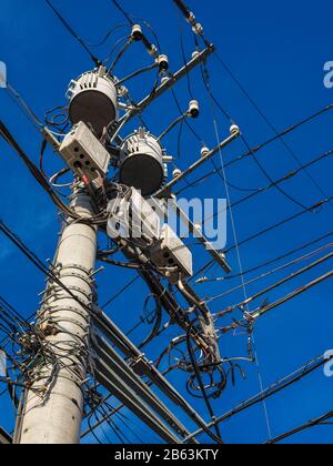 Electric power industry. Characteristic utility and transmission pole and overhead power lines in Japan Stock Photo