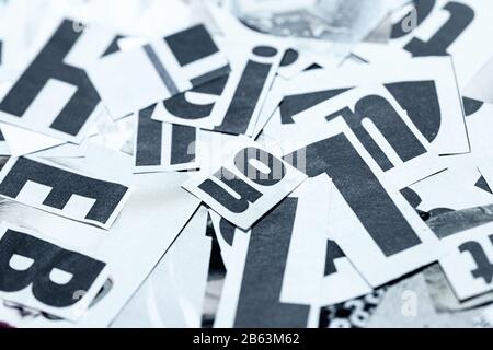 Creative backgroun made of newspaper cutout fonts scattered on table top Stock Photo