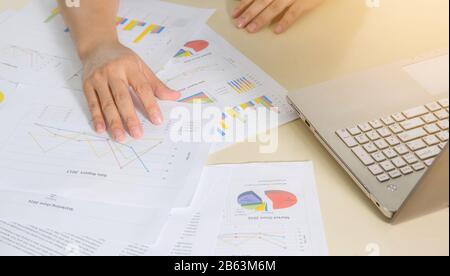 Financial paper charts, graphs and notebook on the table Stock Photo