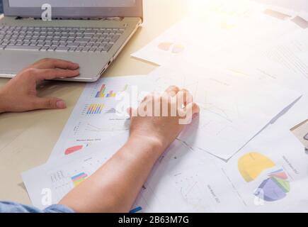 Financial paper charts, graphs and notebook on the table Stock Photo