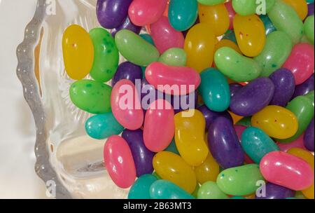 An antique glass candy dish filled with colourful Easter candies. Stock Photo