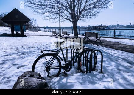 Abandoned bike in the snow on Notre Dame Island, Montreal - Winter landscape Stock Photo