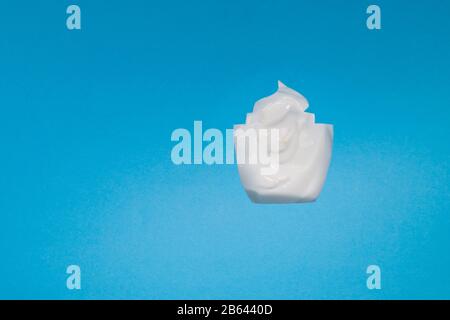 the mask cream to the face and body under craft paper. Texture for design, abstract background. Cosmetics. Cream white background texture with paper Stock Photo