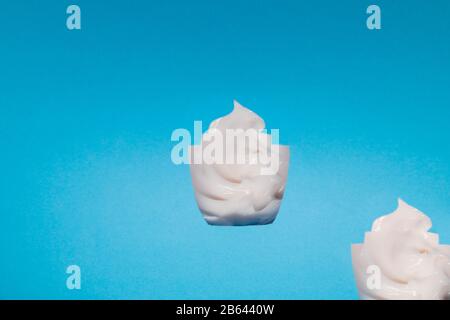 the mask cream to the face and body under craft paper. Texture for design, abstract background. Cosmetics. Cream white background texture with paper Stock Photo