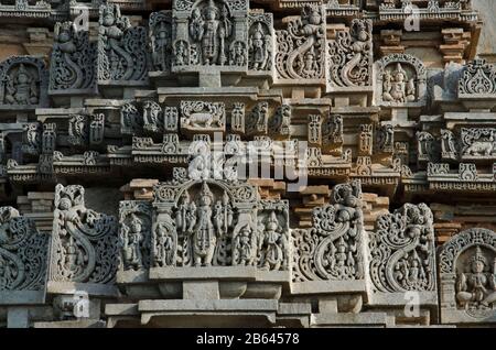 Carved idols on the outer wall of Veera Narayana temple, it was built during the rule of the Hoysala Empire,  Belavadi, Karnataka, India Stock Photo