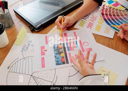 Close-up image of UI designers discussing project of mobile application and making corrections Stock Photo