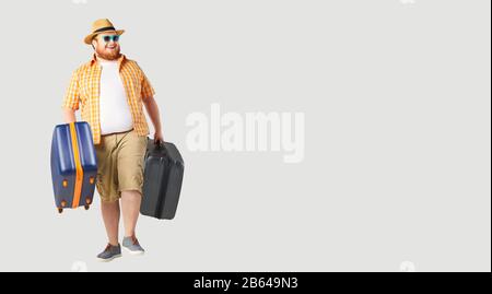 Fat funny man a suitcase smiling goes on a gray background. Stock Photo