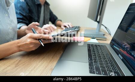 Collaborative work Software engineers website developer technologies or programmer working coding on startup ai application project on screen with par Stock Photo