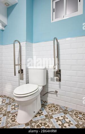 Adapted toilet for disabled people. Hotel room interior easy access Stock Photo