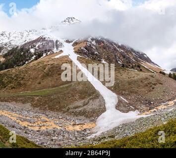 Landscape with a trace of recent avalanches in the mountains of the Caucasus Stock Photo