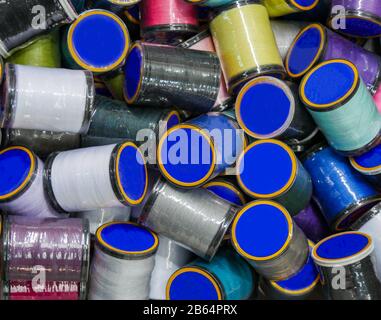 A bunch of colorful threads on the reels. Selective focus. Stock Photo