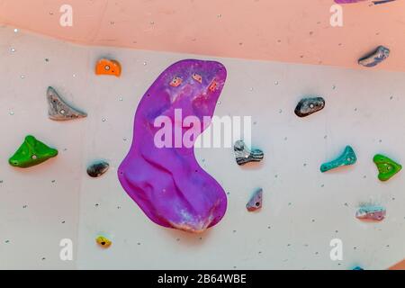 Artificial climbing wall in an indoor climbing gym Stock Photo