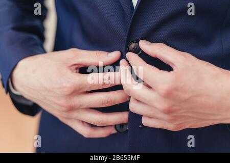 Hands of wedding groom getting ready in suit Stock Photo