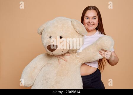 Girl hugging sale huge teddy bear