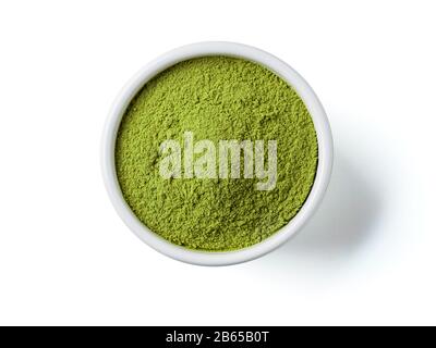 Green matcha tea powder in small white bowl on white background. Powdered maccha tea, isolated on white with clipping path. Top view or flat lay. Copy space for text or design Stock Photo