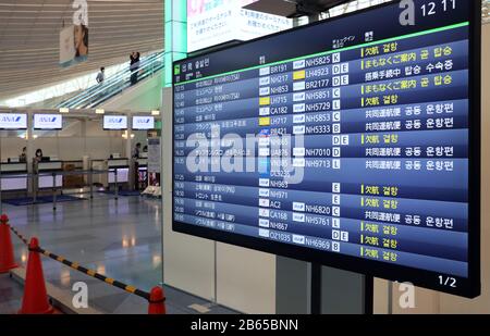 Tokyo, Japan. 10th Mar, 2020. The international terminal of the Haneda airport displays a flight information board for departure which shows some cancellation flights to China and South Korea in Tokyo on Tuesday, March 10, 2020. Japanese government has imposed an entry ban on people from China and South Korea to prevent coronavirus outbreak. Credit: Yoshio Tsunoda/AFLO/Alamy Live News Stock Photo