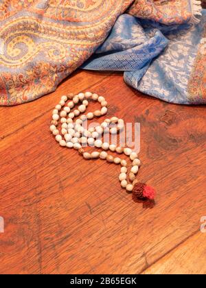 a pebble colored Indian necklace on a wooden table Stock Photo