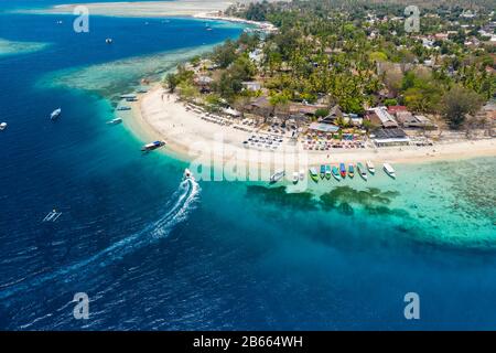 Aerial view of boats moored off a beautiful tropical coral reef and beach on a small island (Gili Air, Indonesia) Stock Photo