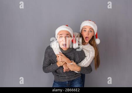 Young couple studio isolated on grey wall concept Stock Photo