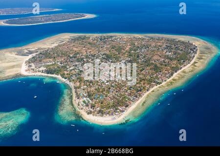 Panoramic aerial drone view of beautiful tropical islands surrounded by coral reef. (Gili Islands, Indonesia) Stock Photo