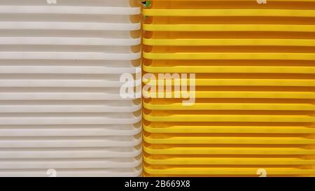 Stack of white and yellow recycled plastic containers in a store. Background. Rhythm. Stock Photo