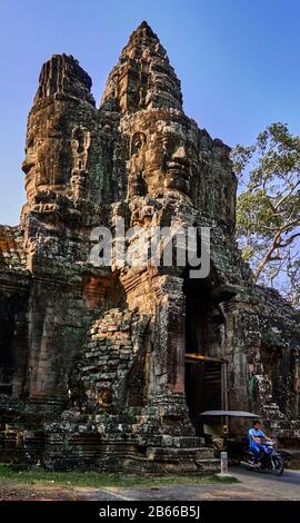 Archeological site ,The South Gate of Angkor Thom leads to Bayon Temple. Lined with 54 stone figures engaged in a performance of a famous Hindu story, it extends about 50 metres across a moat. Stock Photo