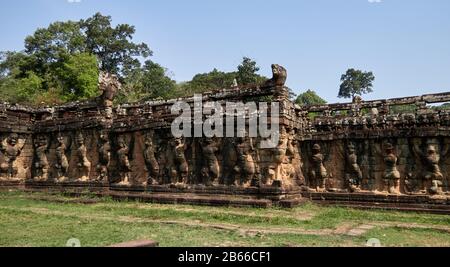 The Leper King's Terrace is part of the walled city of Angkor Thom, a ruined temple complex in Cambodia. The terrace was used by Angkor's king Jayavarman VII as a platform from which to view his victorious returning army. It was attached to the palace of Phimeanakas, of which only a few ruins remain. Most of the original structure was made of organic material and has long since disappeared. Stock Photo