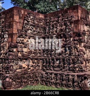 The Leper King's Terrace is part of the walled city of Angkor Thom, a ruined temple complex in Cambodia. The terrace was used by Angkor's king Jayavarman VII as a platform from which to view his victorious returning army. It was attached to the palace of Phimeanakas, of which only a few ruins remain. Most of the original structure was made of organic material and has long since disappeared. Stock Photo