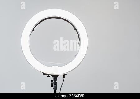 Closeup of circular neon LED lamp at white background. Popular modern light for make-up and beauty portraits Stock Photo