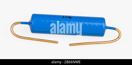 Blue metallized power electronic resistor with gilded terminal wires on white background. One passive electrical component. Electrotechnics industry. Stock Photo