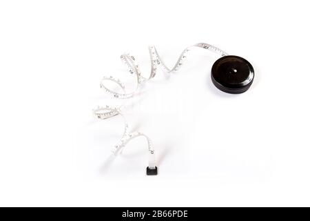Measuring tape on white background. Tape measure on a roll Stock Photo