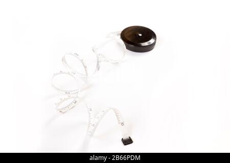 Measuring tape on white background. Tape measure on a roll Stock Photo