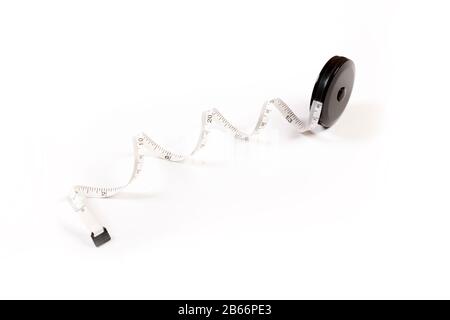 Measuring tape on white background. Tape measure on a roll Stock Photo