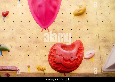 climbing wall at modern gym with colored various hooks Stock Photo