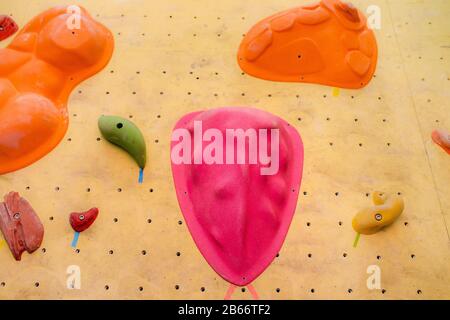 climbing wall at modern gym with colored various hooks Stock Photo
