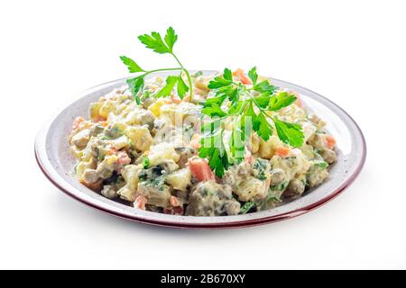 The vinaigrette of various boiled vegetables in the plate on white Stock Photo