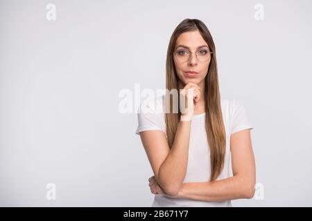 Photo of pretty lady looking with interest arm touch chin wear specs and t-shirt isolated white background Stock Photo