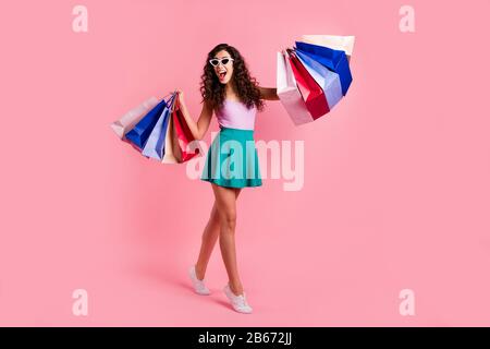 Full length body size photo of funky funny positive cheerful cute girlfriend wearing teal skirt while isolated with pink pastel background Stock Photo